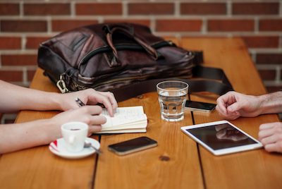 business meeting over coffee and tablets